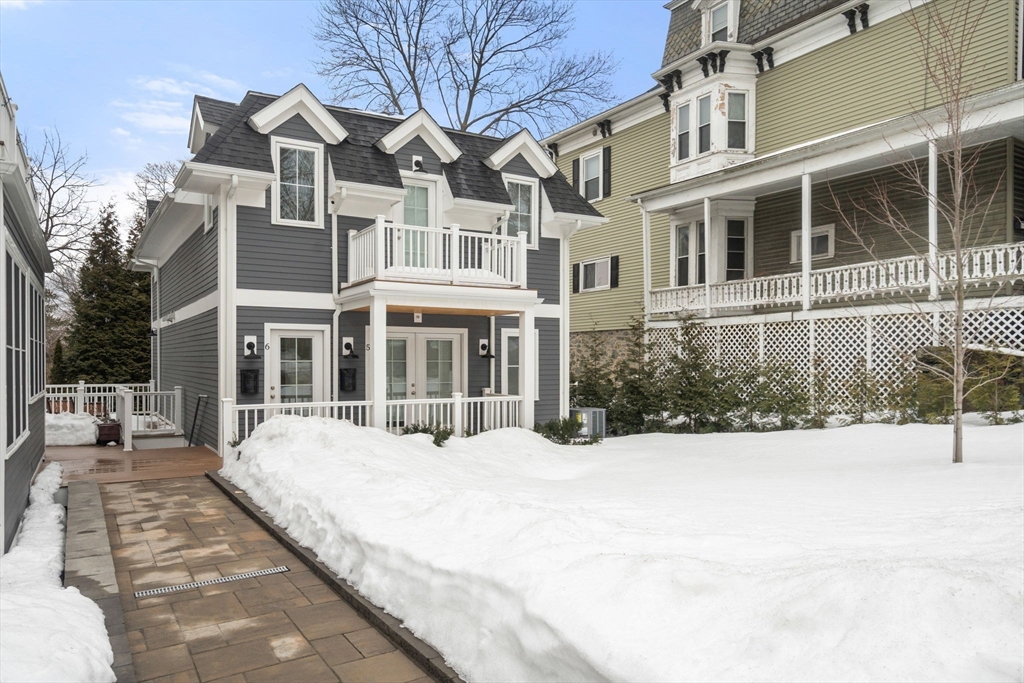 68 Chestnut Street, Unit 6 Newton, MA 02465 - Photo 22 of 22 a view of a building with a bench in front of house