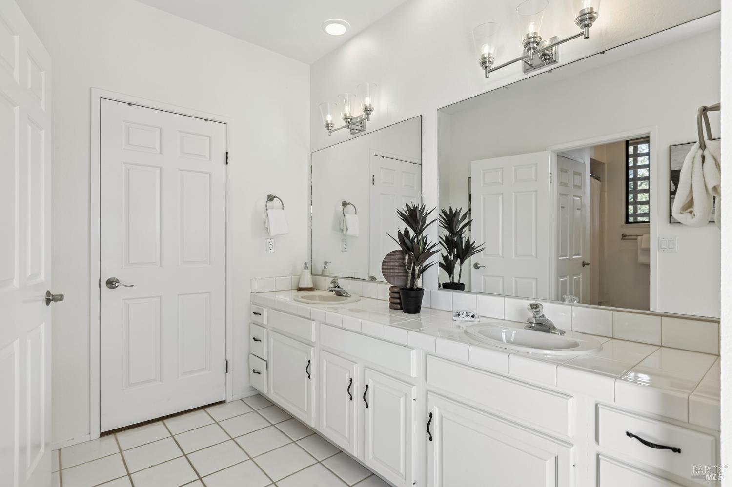 103 Holstein Road San Anselmo, CA 94960 - Photo 41 of 66 a bathroom with a double vanity sink and a mirror