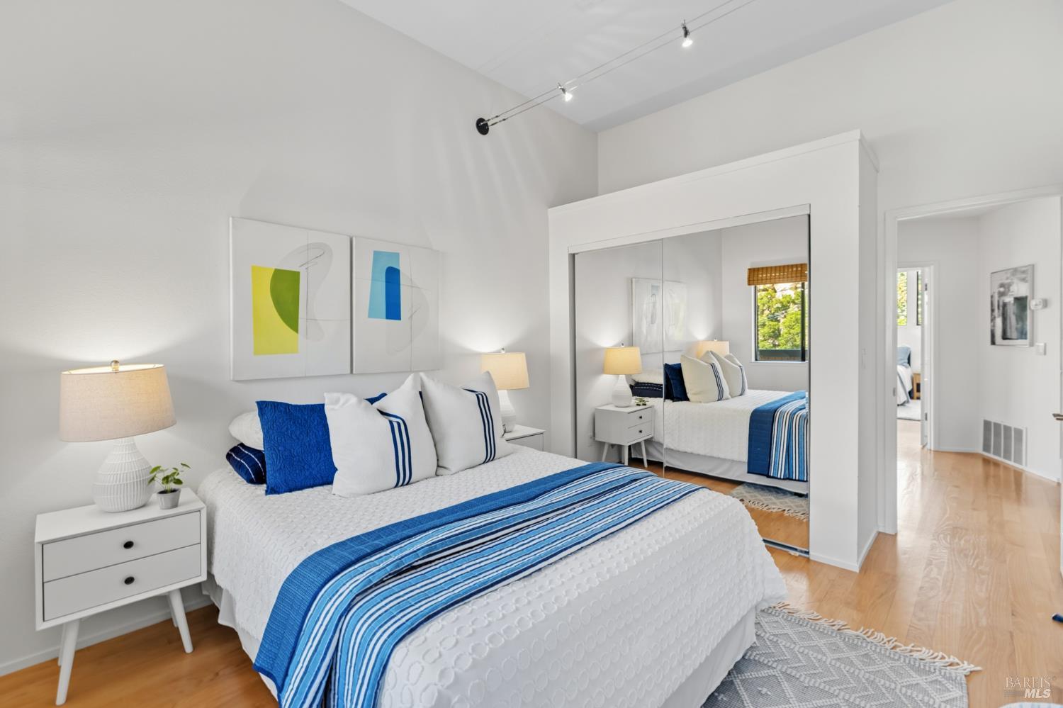 103 Holstein Road San Anselmo, CA 94960 - Photo 44 of 66 a bedroom with a bed and a wooden floor