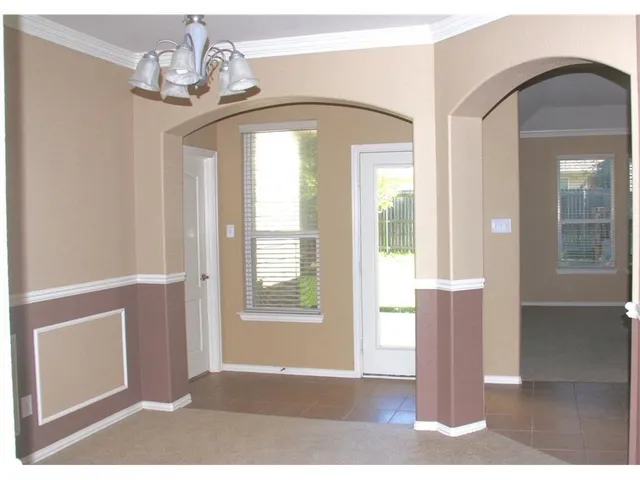 a view of a livingroom with wooden floor and windows