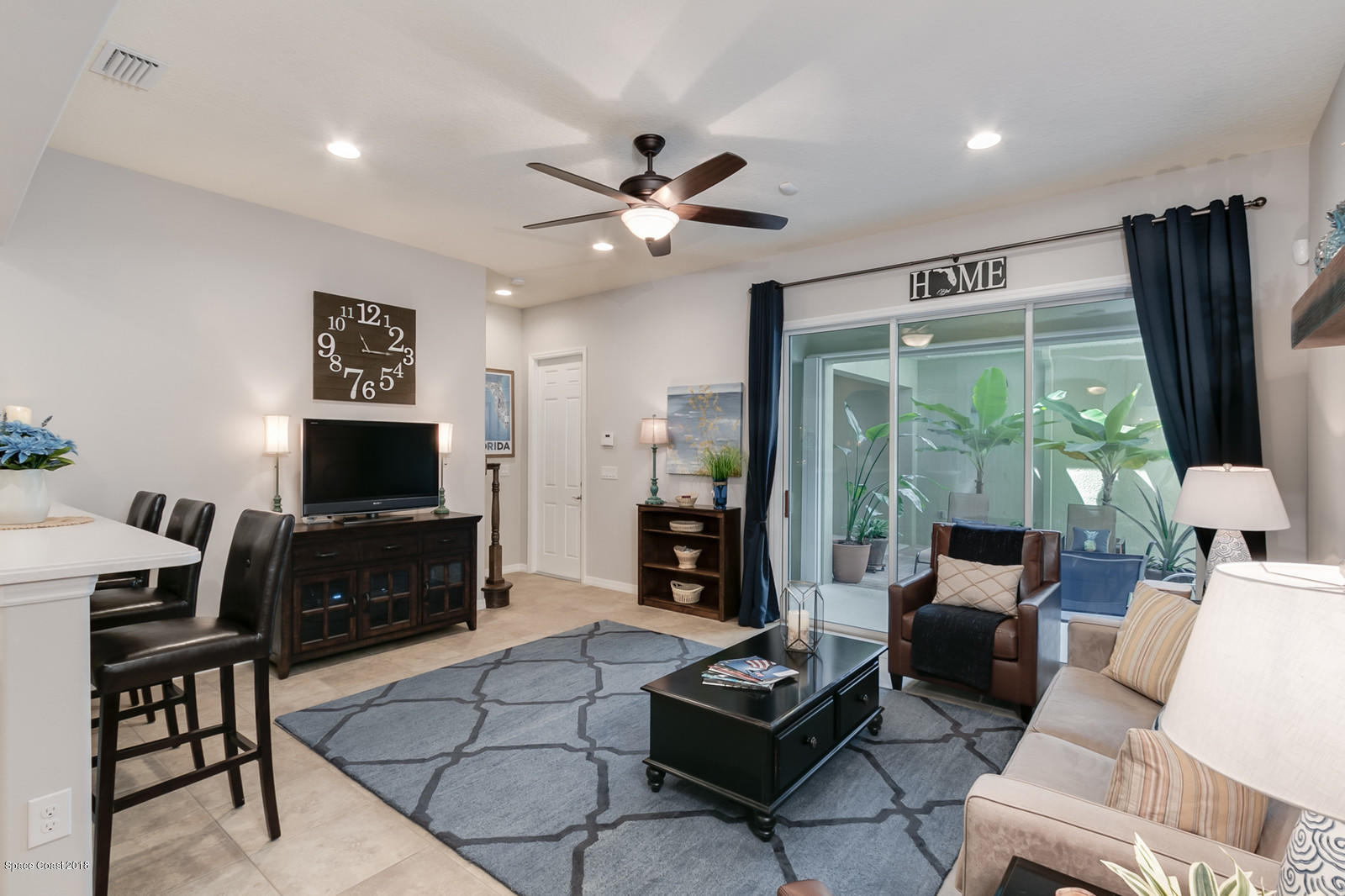 3225 Sedge Drive Rockledge, FL 32955 - Photo 13 of 35 a living room with furniture a flat screen tv and a large window