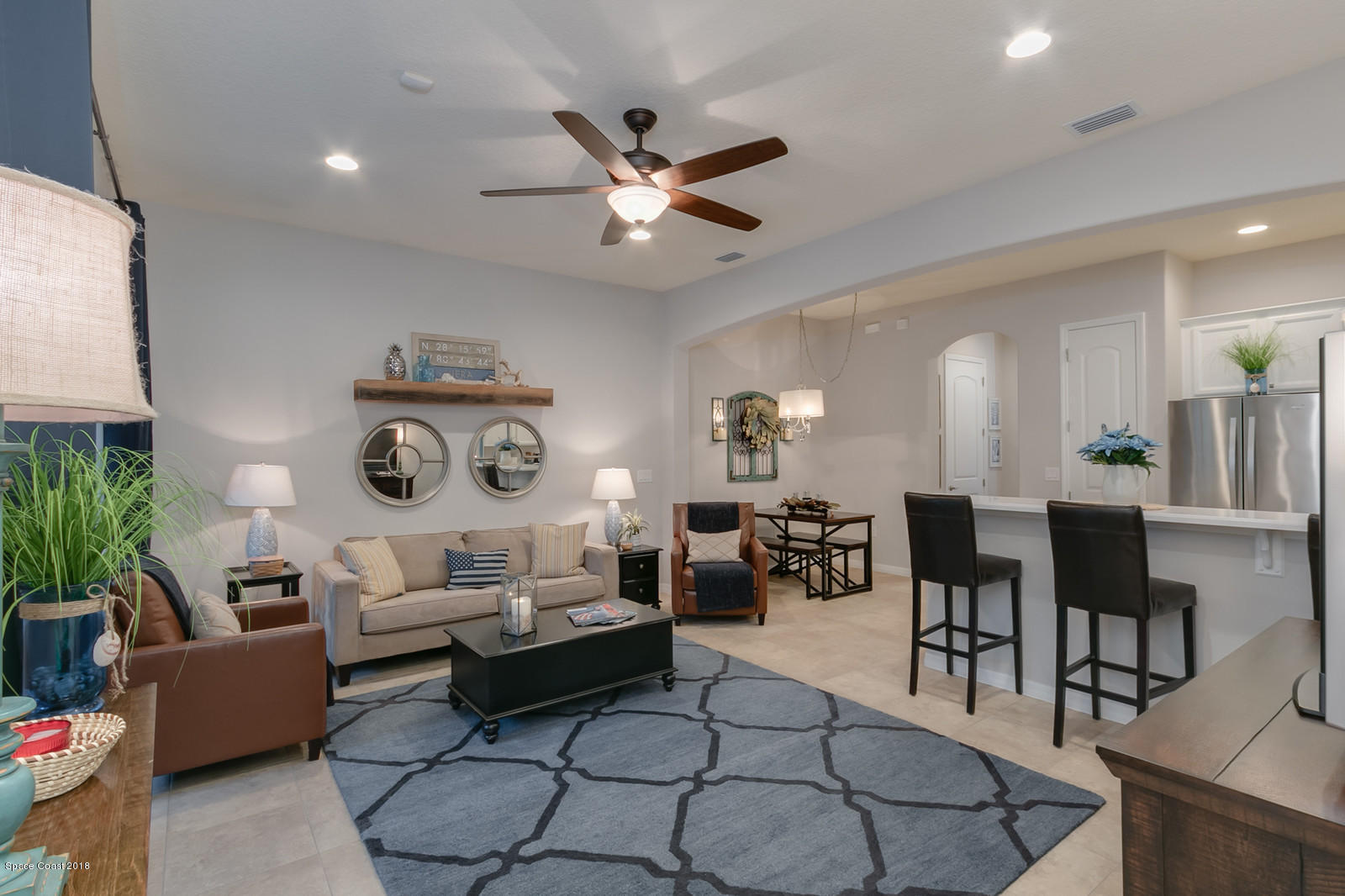 3225 Sedge Drive Rockledge, FL 32955 - Photo 14 of 35 a living room with furniture a rug and a clock