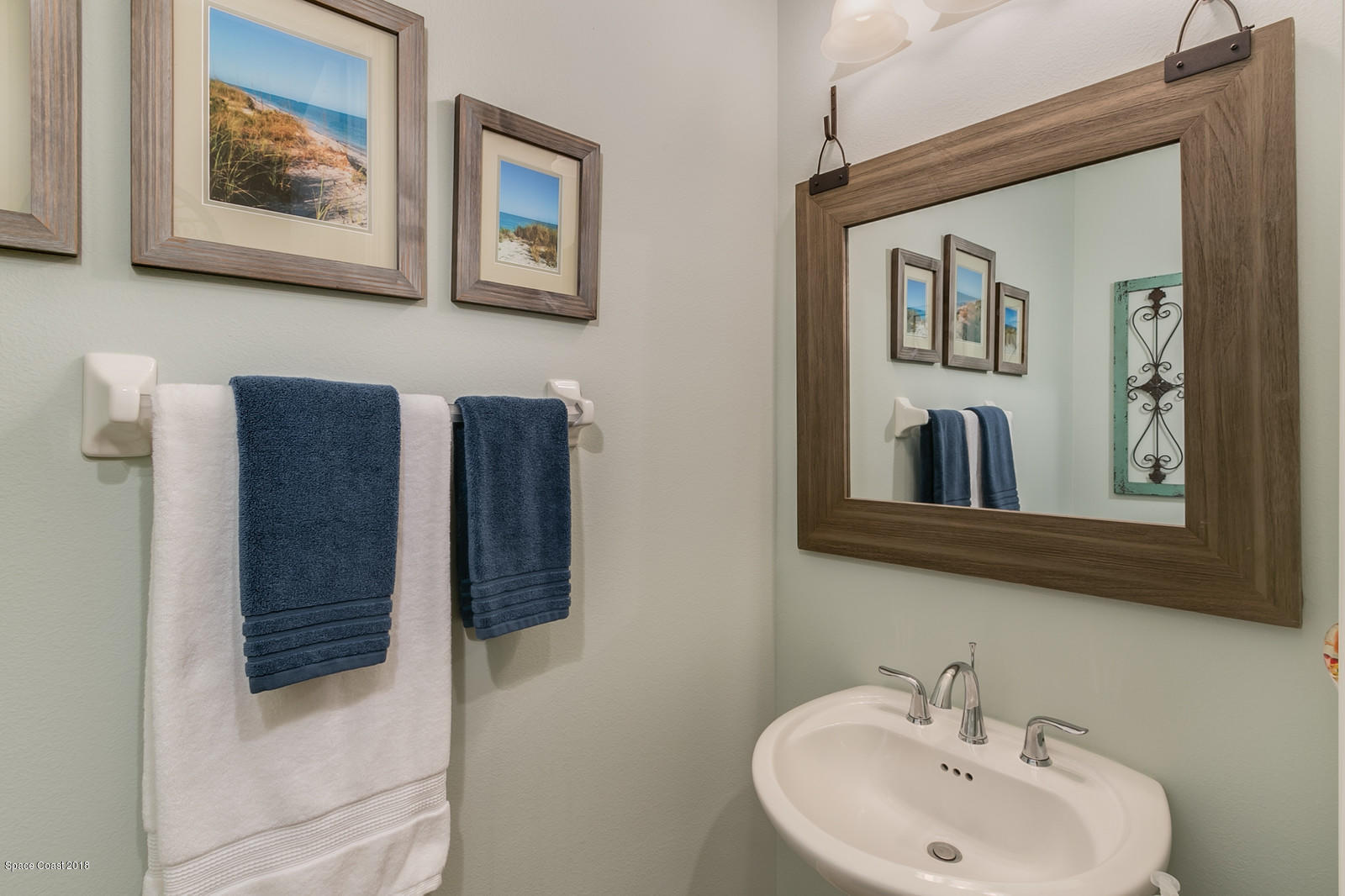 3225 Sedge Drive Rockledge, FL 32955 - Photo 16 of 35 a bathroom with a sink and a mirror