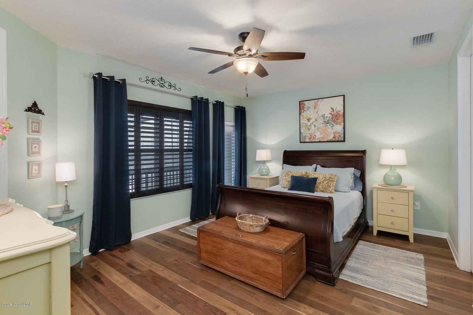 3225 Sedge Drive Rockledge, FL 32955 - Photo 17 of 35 a bedroom with a bed and a chandelier