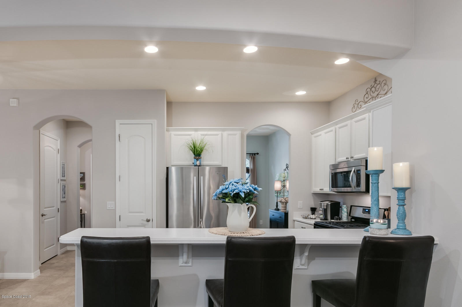 3225 Sedge Drive Rockledge, FL 32955 - Photo 9 of 35 a dining room with furniture a sink and a large mirror