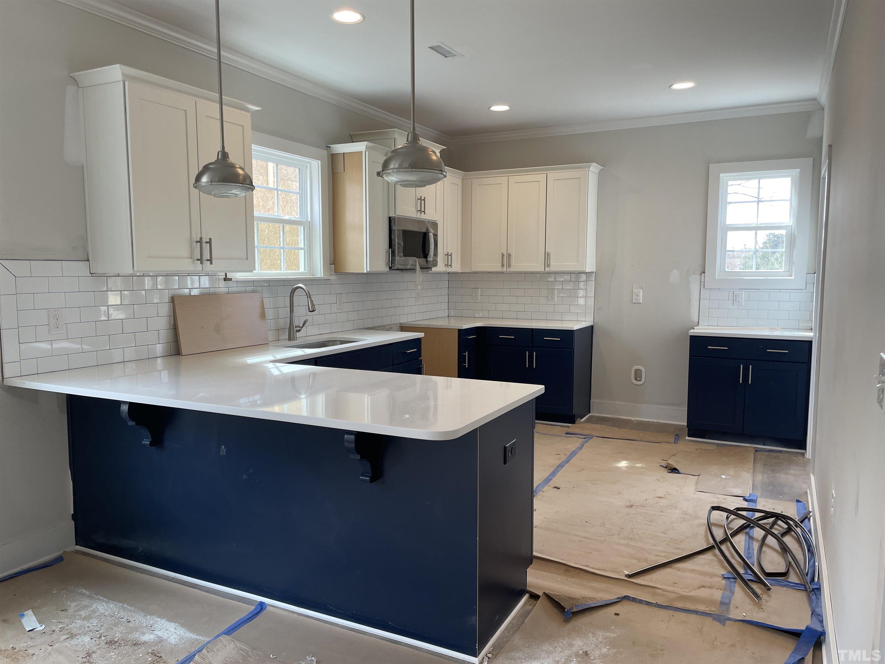 1306 Castlebay Road Durham, NC 27704 - Photo 3 of 4 a kitchen with kitchen island granite countertop a sink and a stove