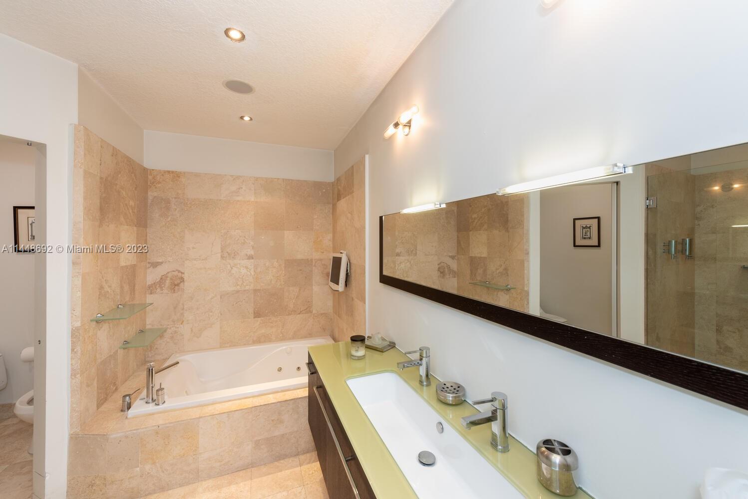 2401 Anderson Road, Unit 3 Coral Gables, FL 33134 - Photo 18 of 46 a bathroom with a tub sink and mirror