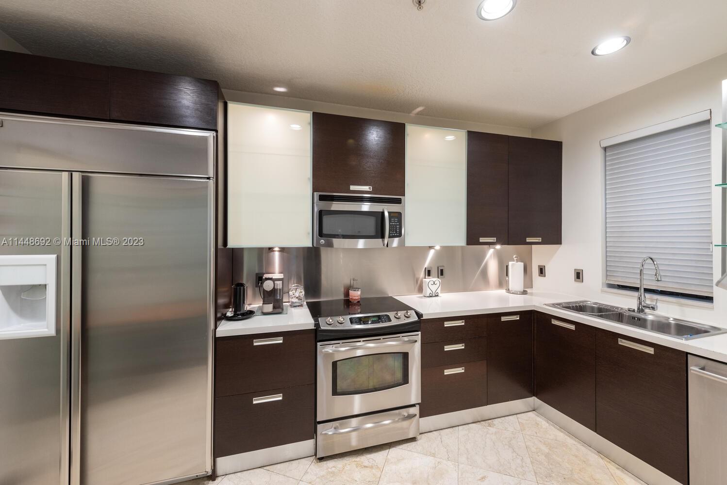 2401 Anderson Road, Unit 3 Coral Gables, FL 33134 - Photo 8 of 46 a kitchen with a sink and stainless steel appliances