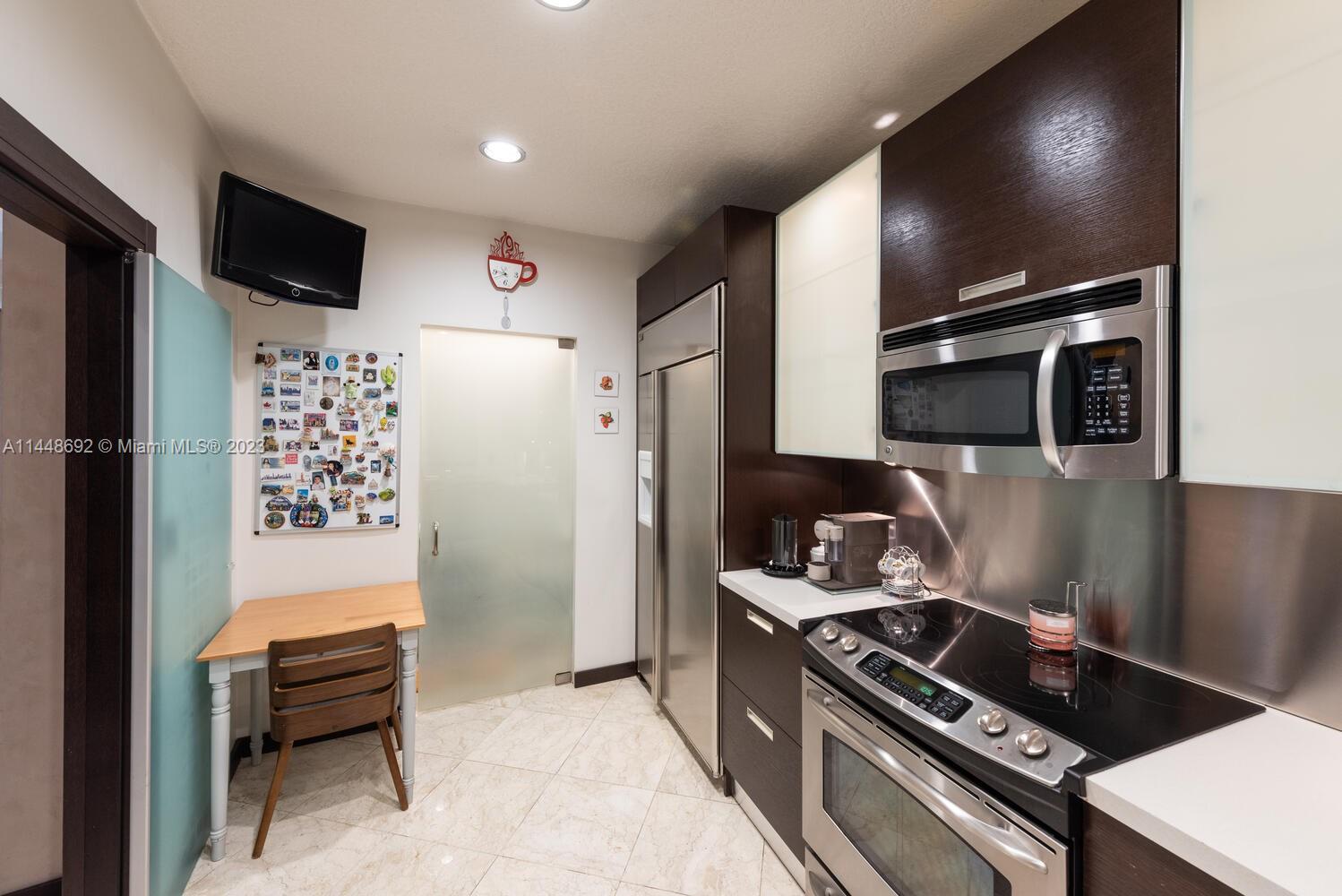 2401 Anderson Road, Unit 3 Coral Gables, FL 33134 - Photo 9 of 46 a kitchen with stainless steel appliances a refrigerator a stove and a microwave