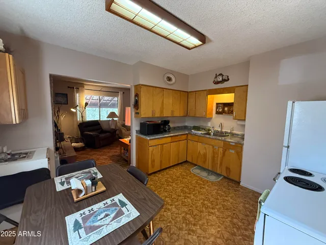 a kitchen with a refrigerator and a stove top oven