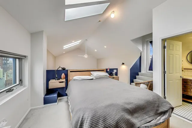 a large bedroom with a bed and a tv on table