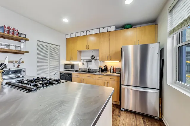 a kitchen with a refrigerator and a stove top oven