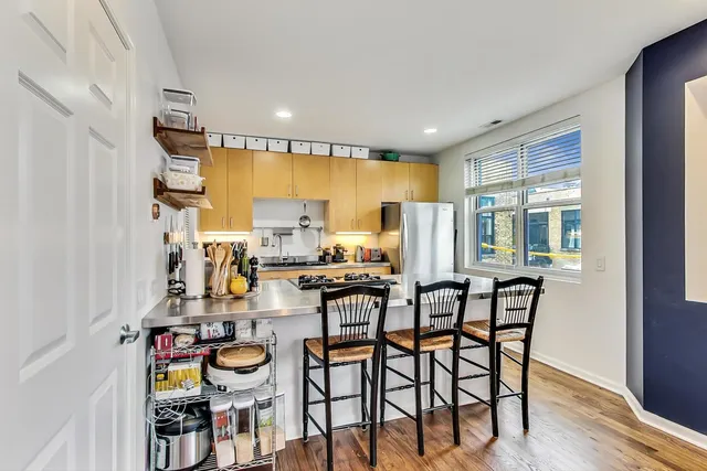 a view of a dining room with furniture a chandelier and wooden floor