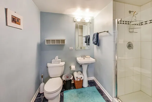 a bathroom with a sink mirror toilet and shower