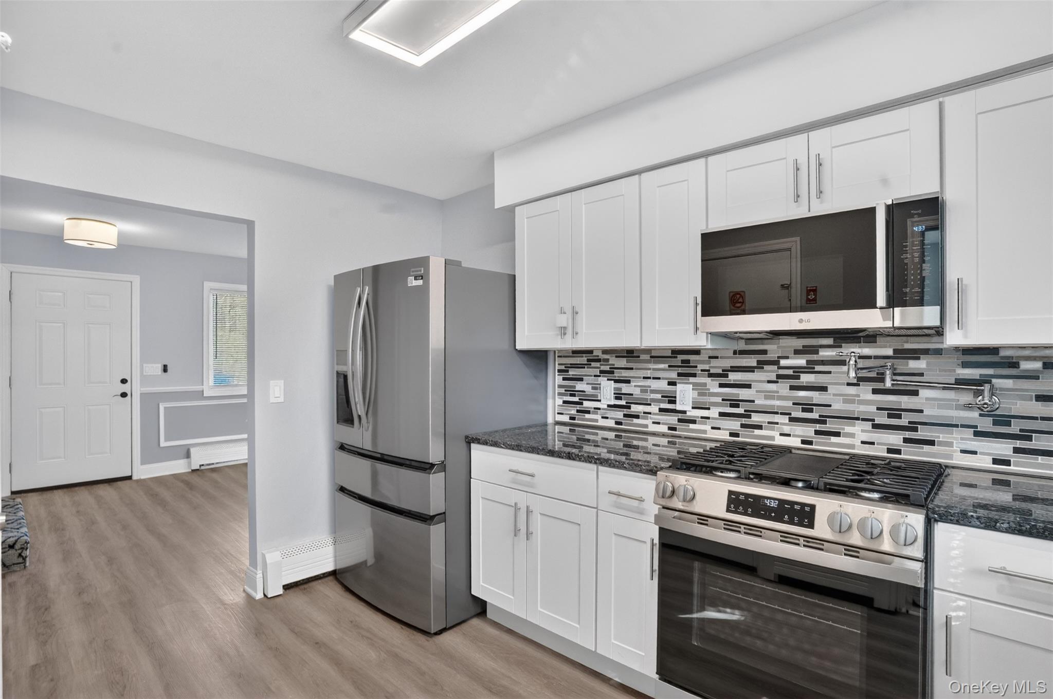 15 North Aspen Road Middletown, NY 10940 - Photo 9 of 16 a kitchen with stainless steel appliances a stove microwave and refrigerator