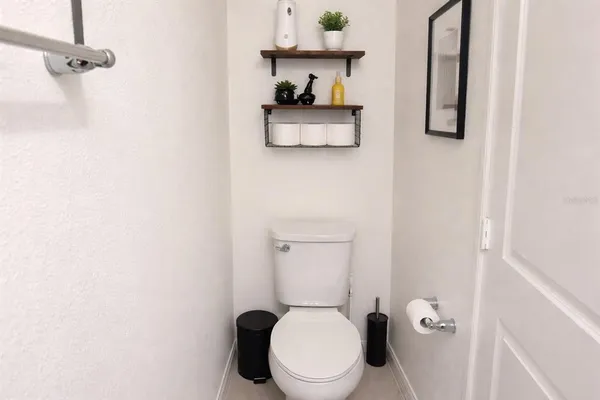 a white toilet sitting next to a bathroom sink