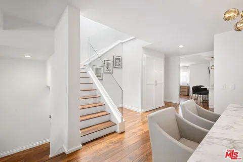 a view of a room with wooden floor and a bathroom