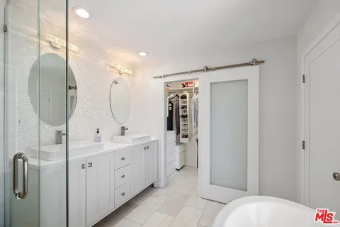 a large white bed in a white room