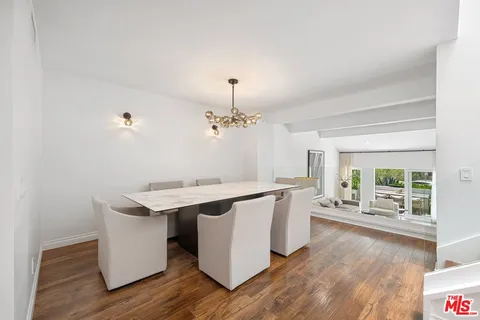 a kitchen with a sink appliances wooden floor and cabinets