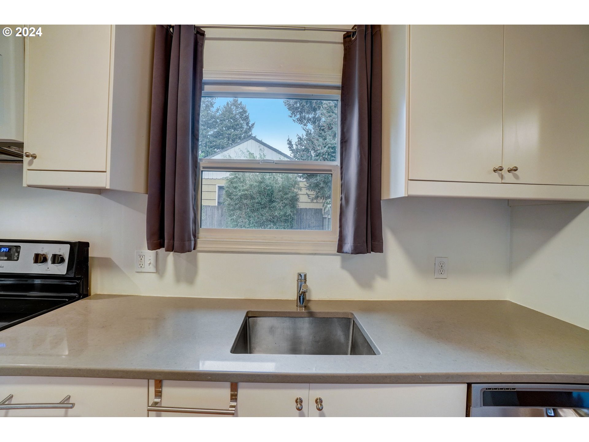 1248 North Watts Street Portland, OR 97217 - Photo 15 of 36 a kitchen with kitchen island a stove and a sink with wooden floor