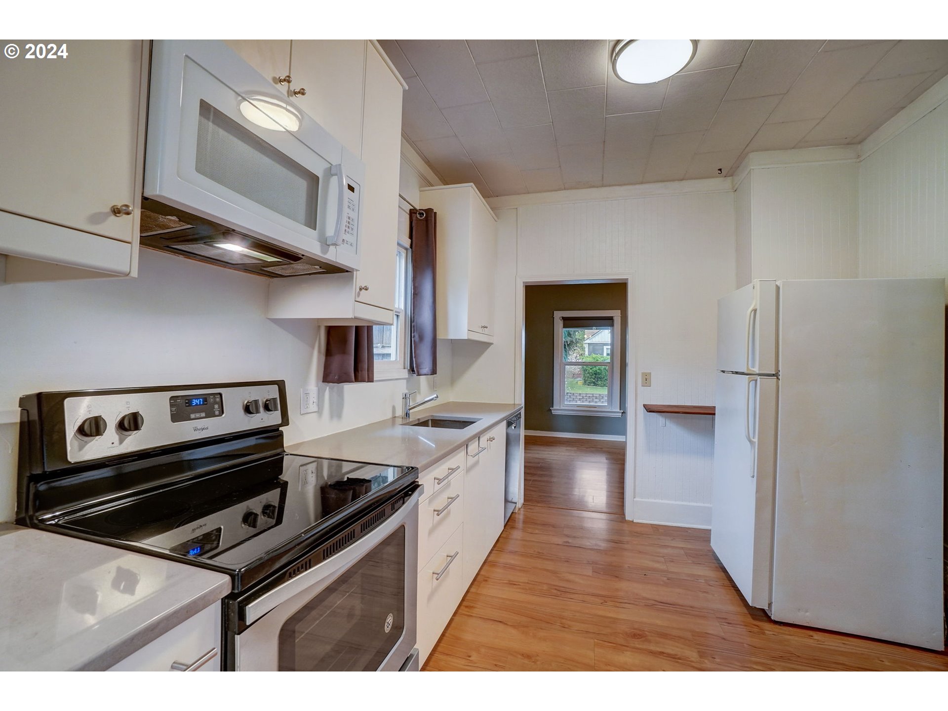 1248 North Watts Street Portland, OR 97217 - Photo 16 of 36 a kitchen with stainless steel appliances a stove a sink and a refrigerator