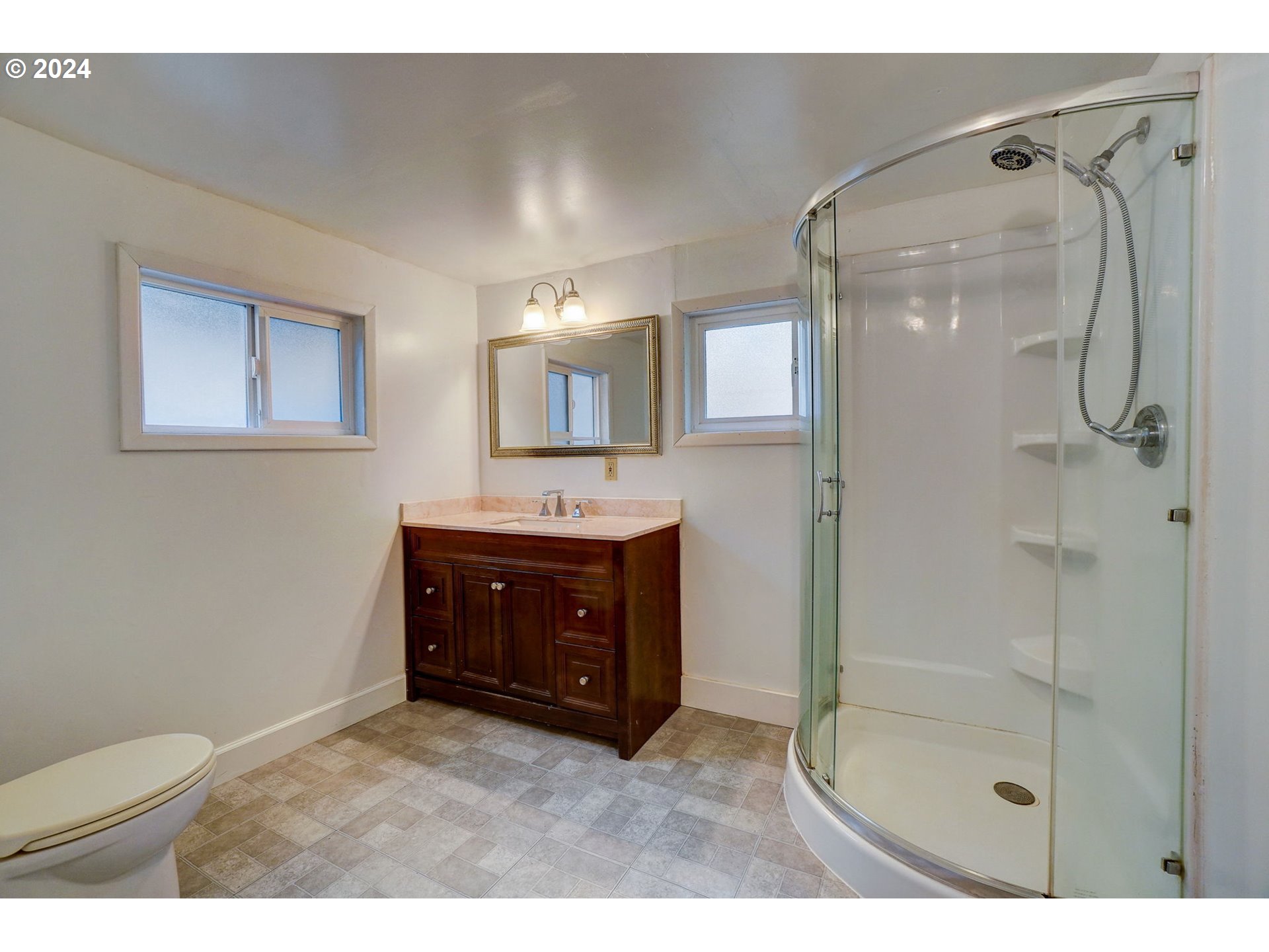 1248 North Watts Street Portland, OR 97217 - Photo 27 of 36 a bathroom with a sink a toilet and shower