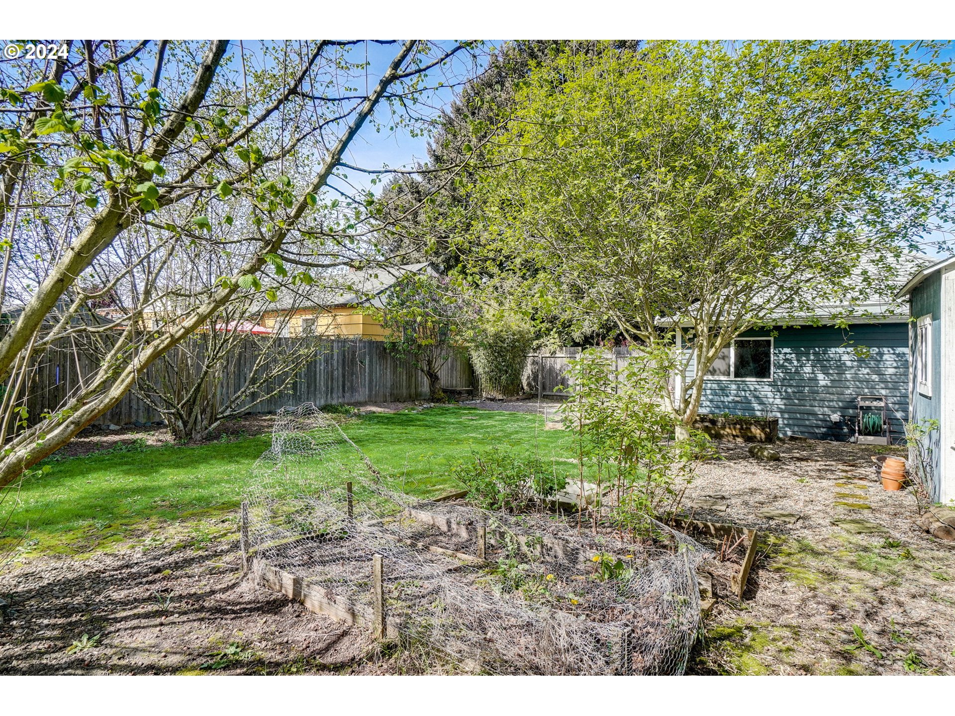 1248 North Watts Street Portland, OR 97217 - Photo 33 of 36 a backyard of a house with plants and large tree