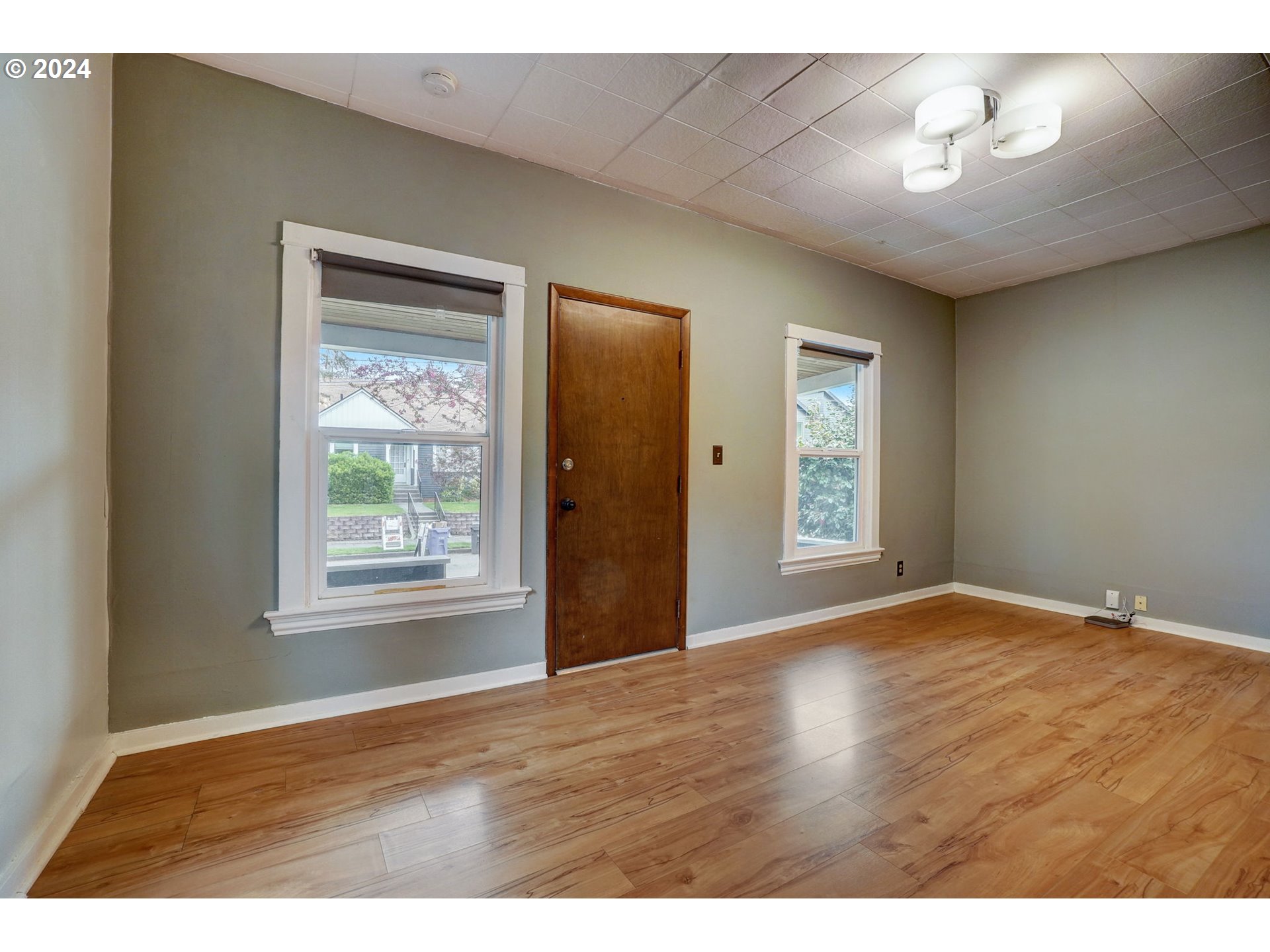 1248 North Watts Street Portland, OR 97217 - Photo 10 of 36 a view of an empty room with a window and wooden floor