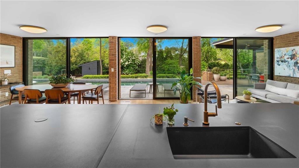 1671 Friar Tuck Road Northeast Atlanta, GA 30309 - Photo 17 of 63 a living room with furniture and floor to ceiling windows
