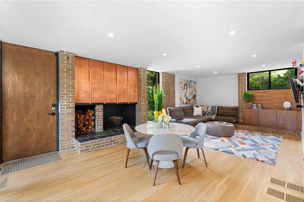 1671 Friar Tuck Road Northeast Atlanta, GA 30309 - Photo 20 of 63 a living room with fireplace furniture and a flat screen tv