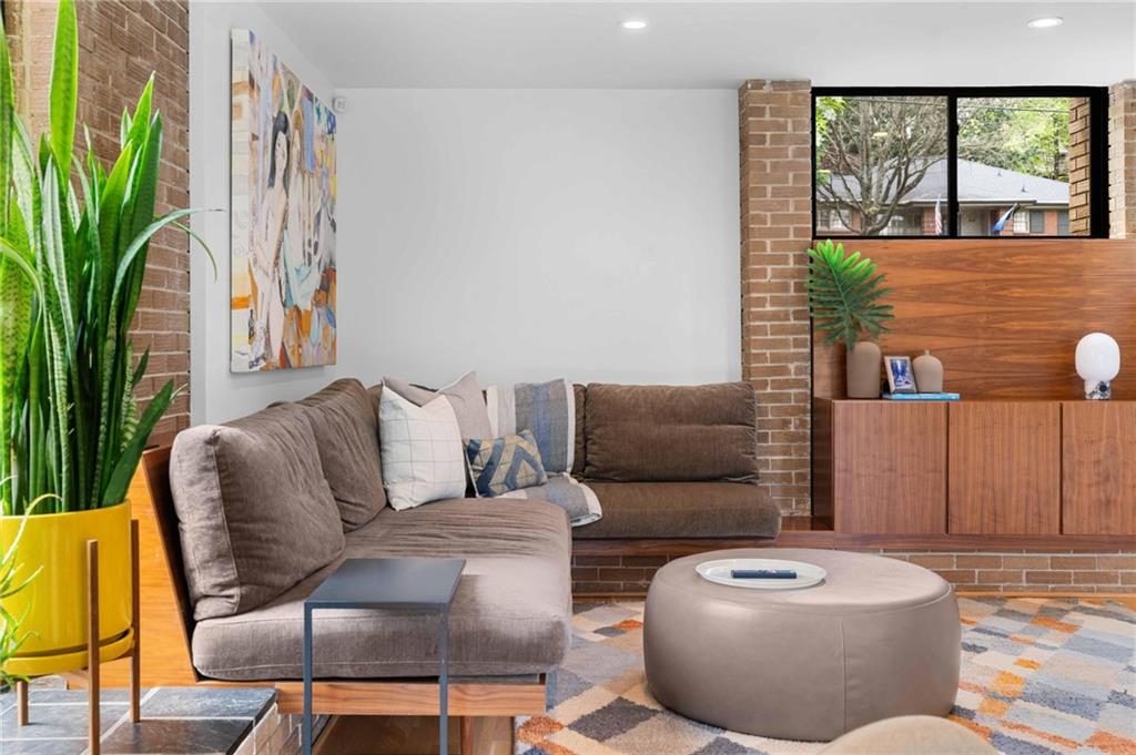 1671 Friar Tuck Road Northeast Atlanta, GA 30309 - Photo 21 of 63 a living room with furniture and a floor to ceiling window