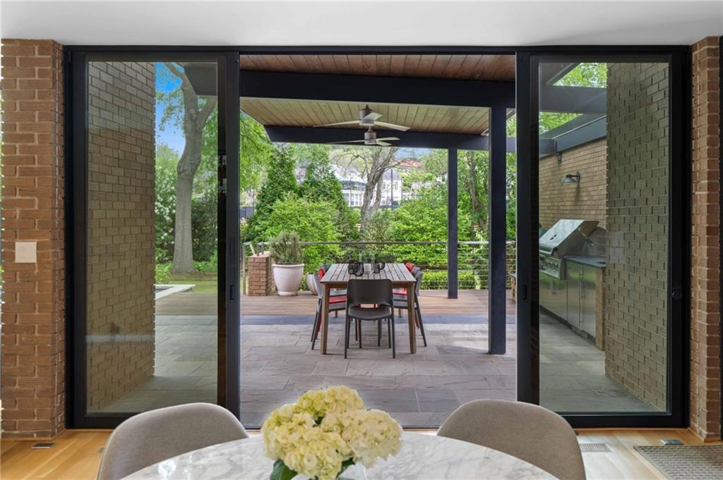 1671 Friar Tuck Road Northeast Atlanta, GA 30309 - Photo 23 of 63 a dining room with furniture and a floor to ceiling window
