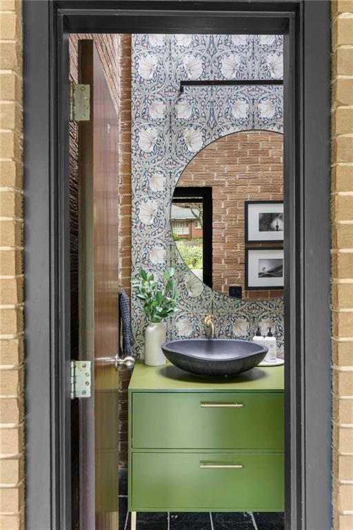 1671 Friar Tuck Road Northeast Atlanta, GA 30309 - Photo 28 of 63 a bathroom with a sink and a mirror