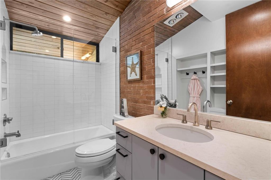 1671 Friar Tuck Road Northeast Atlanta, GA 30309 - Photo 35 of 63 a bathroom with a granite countertop sink toilet and shower