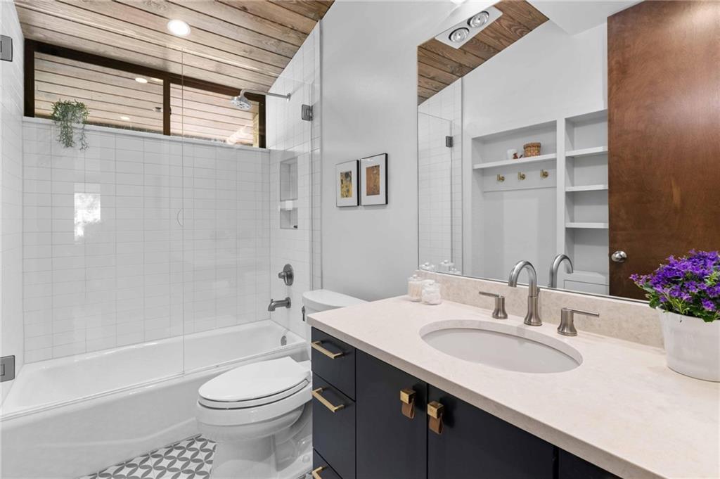 1671 Friar Tuck Road Northeast Atlanta, GA 30309 - Photo 38 of 63 a bathroom with a sink and a mirror