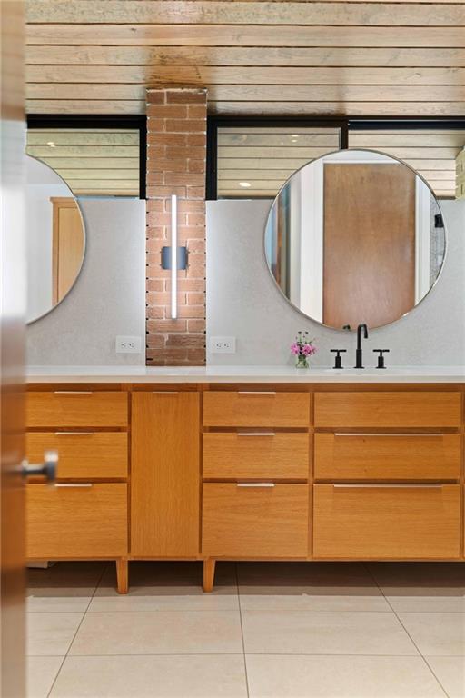 1671 Friar Tuck Road Northeast Atlanta, GA 30309 - Photo 44 of 63 a bathroom with a sink and a mirror