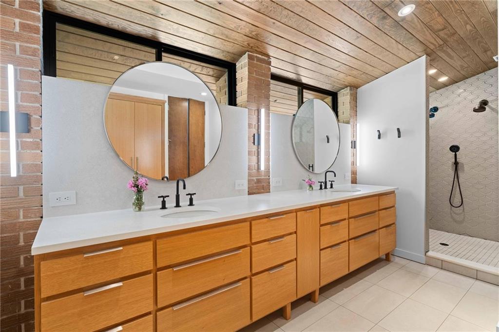 1671 Friar Tuck Road Northeast Atlanta, GA 30309 - Photo 45 of 63 a bathroom with a double vanity sink mirror and shower