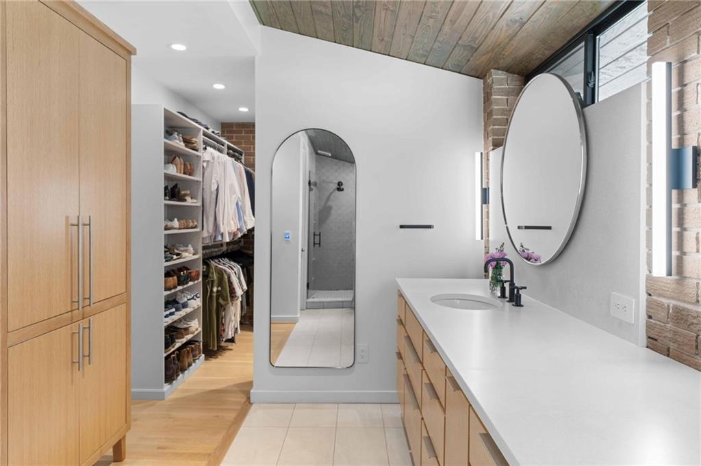1671 Friar Tuck Road Northeast Atlanta, GA 30309 - Photo 47 of 63 a spacious bathroom with a double vanity sink a mirror and a shower