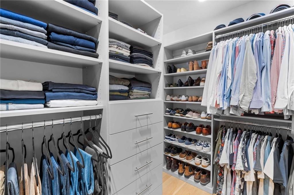1671 Friar Tuck Road Northeast Atlanta, GA 30309 - Photo 48 of 63 a view of walk in closet with clothes and shoes