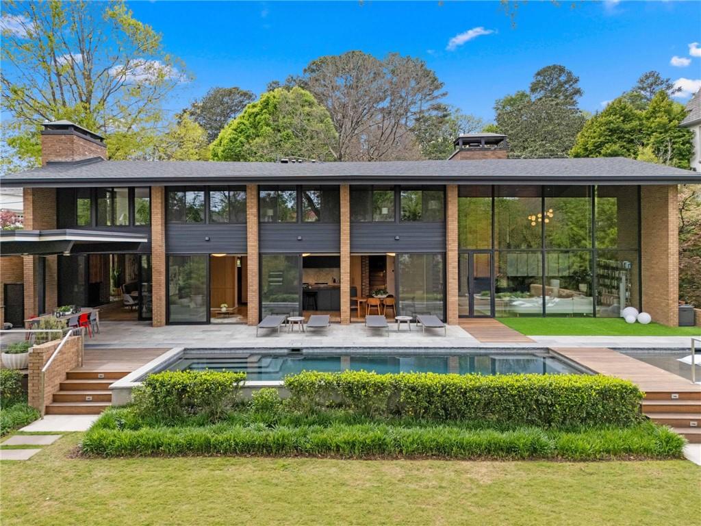 1671 Friar Tuck Road Northeast Atlanta, GA 30309 - Photo 53 of 63 a view of a house with a yard patio and swimming pool