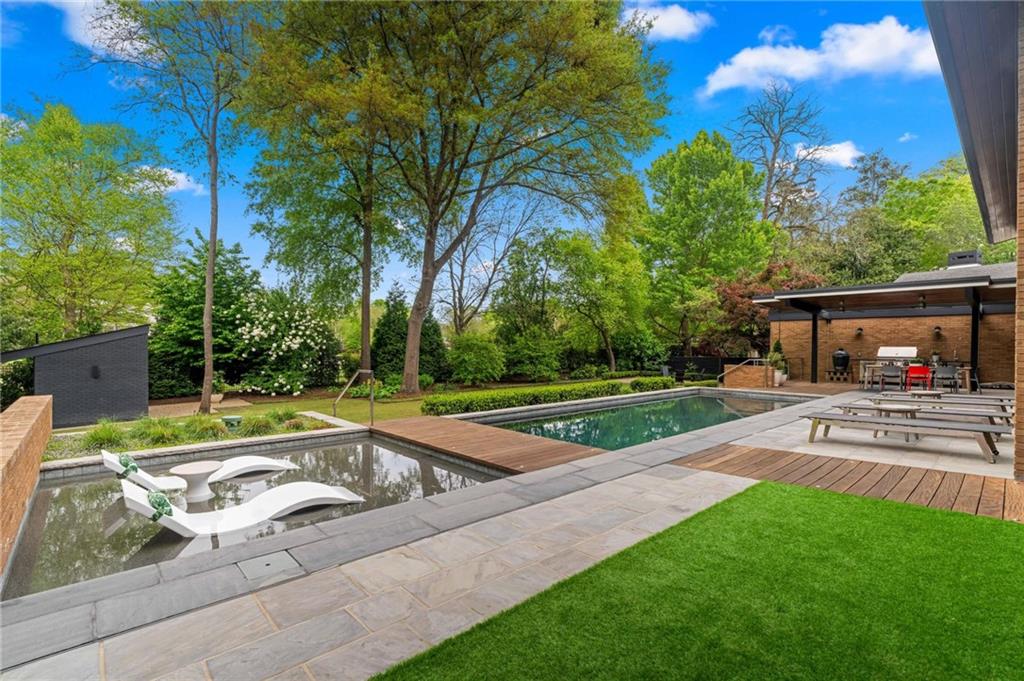 1671 Friar Tuck Road Northeast Atlanta, GA 30309 - Photo 58 of 63 a view of a house with pool and a yard