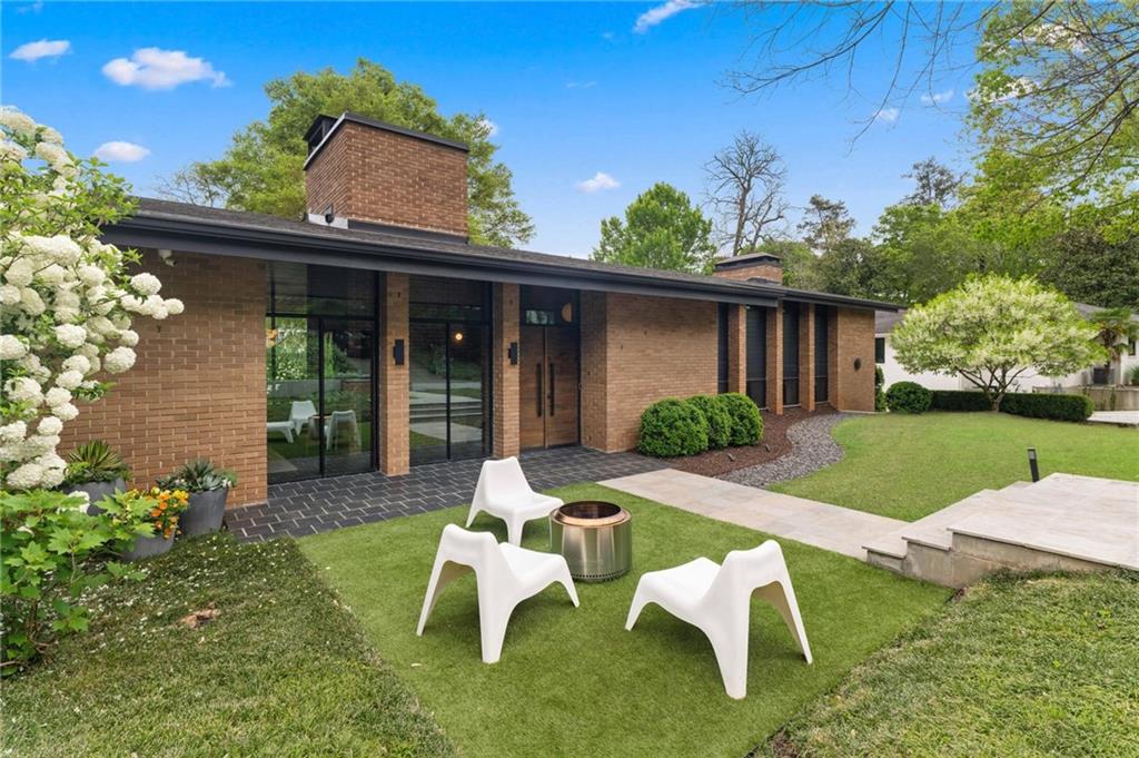 1671 Friar Tuck Road Northeast Atlanta, GA 30309 - Photo 62 of 63 a view of a chair and table in backyard of the house