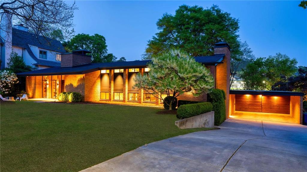 1671 Friar Tuck Road Northeast Atlanta, GA 30309 - Photo 63 of 63 a front view of a house with a yard and a garden