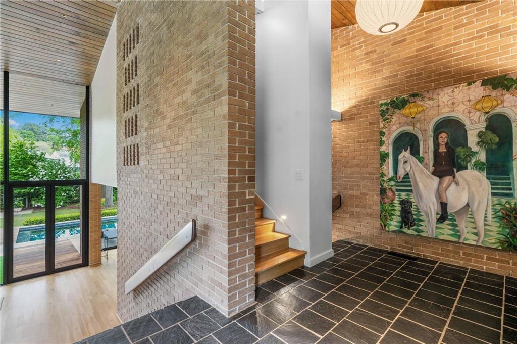 1671 Friar Tuck Road Northeast Atlanta, GA 30309 - Photo 7 of 63 a view of a balcony with wooden floor and iron stairs