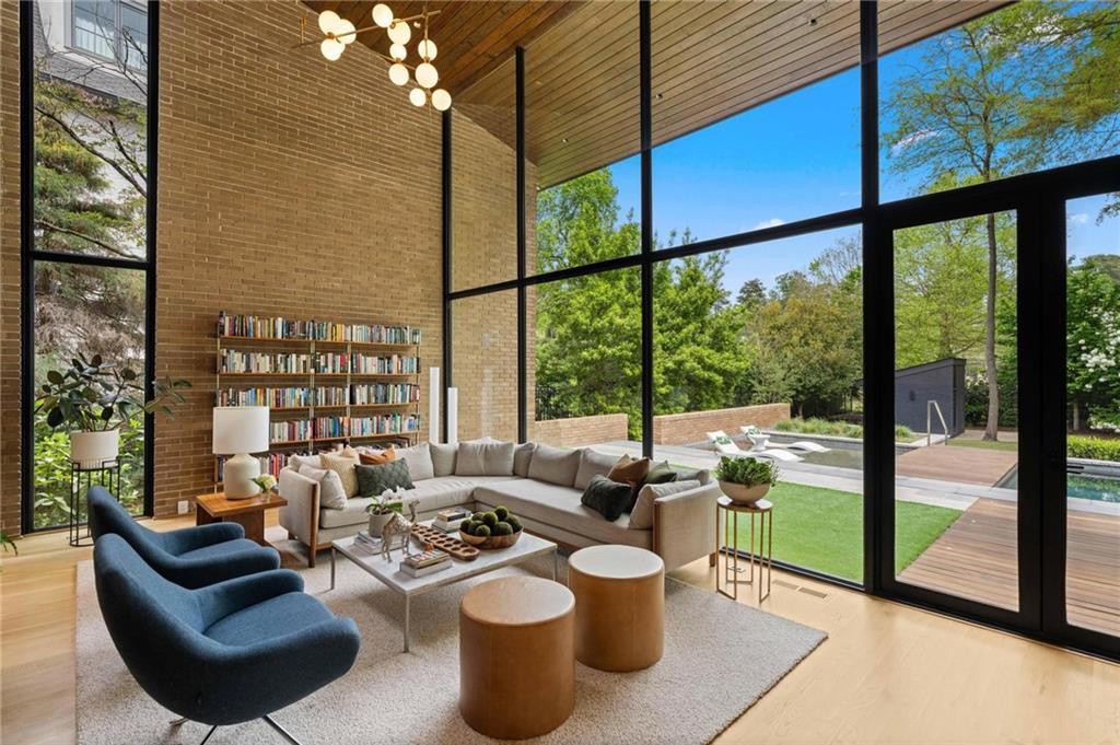 1671 Friar Tuck Road Northeast Atlanta, GA 30309 - Photo 10 of 63 a living room with furniture and a floor to ceiling window