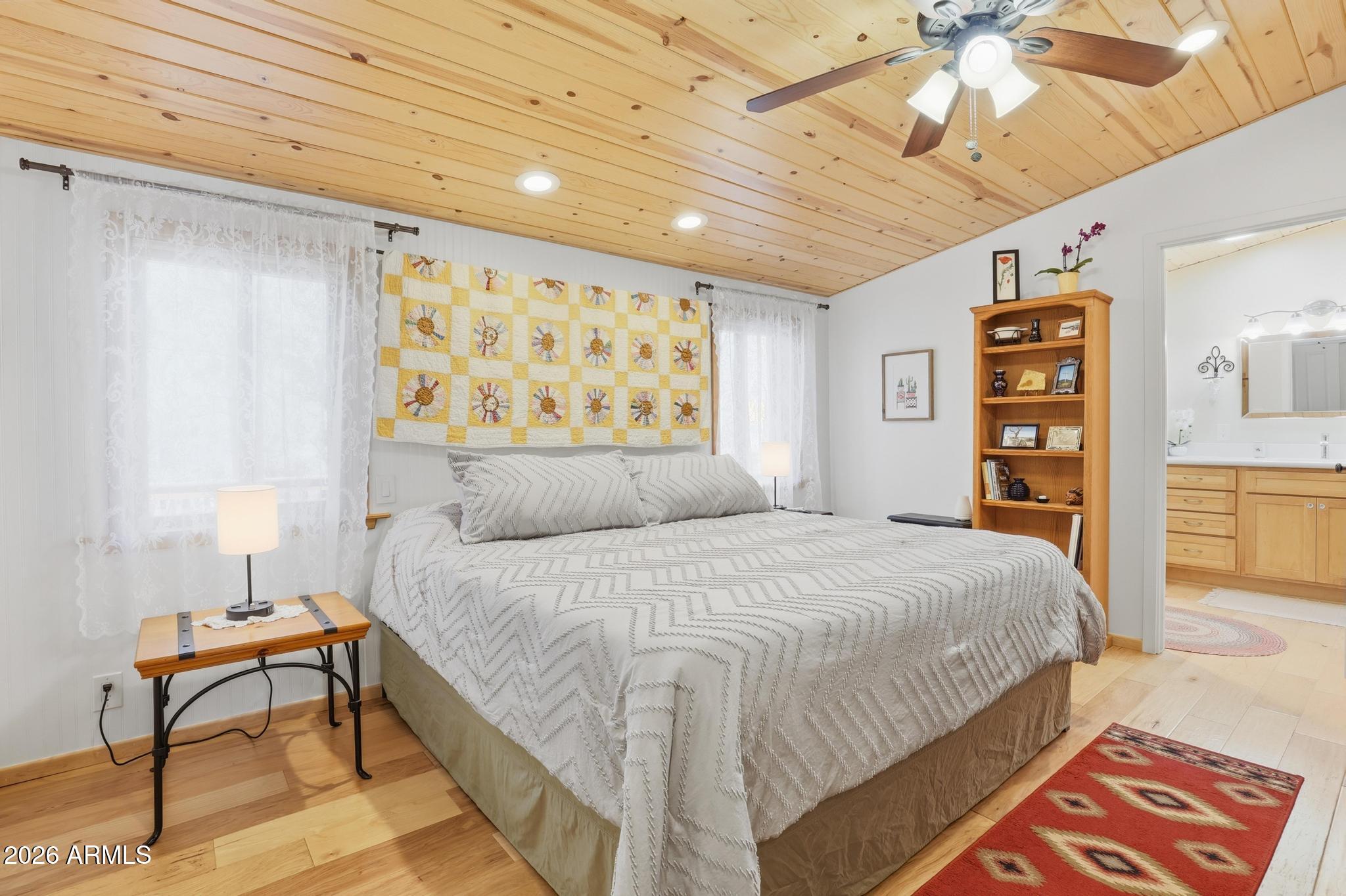 396 Leisure Lane Payson, AZ 85541 - Photo 17 of 61 a spacious bedroom with a bed and a book shelf