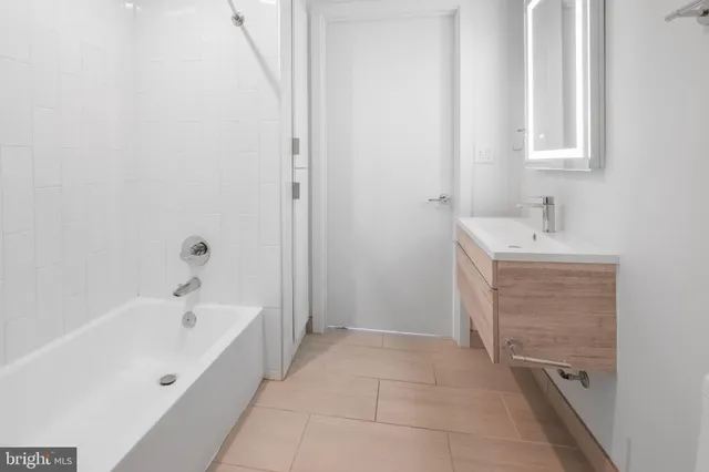 a bathroom with a bathtub and a sink