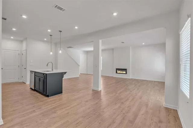 a view of kitchen with refrigerator and window