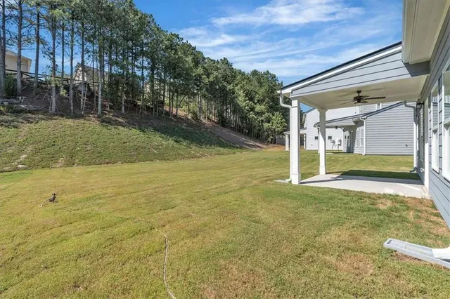 a view of a backyard with swimming pool