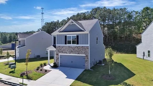 a aerial view of a house with a yard table and chairs